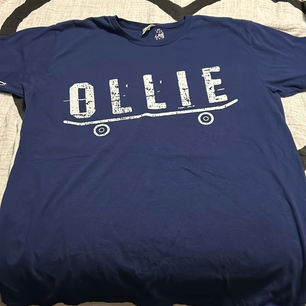 Navy T-shirt with OLLIE written above a skateboard 2/$15